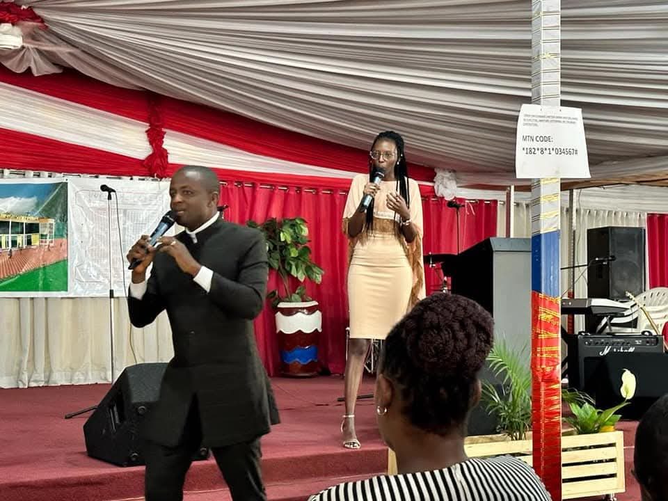 Preaching to a congregation gathered under a marquee